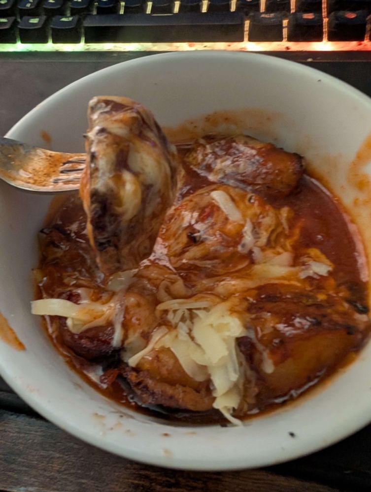 Leftover roast potatoes with cheese and a spicy sauce