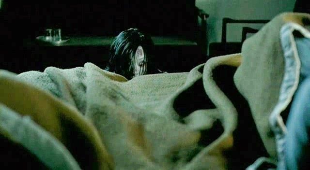 a woman with damp black hair and a pale white face creeping at the edge of a bed

Screenshot from Thai Horror Film, Shutter (2004) by Banjong Pisanthanakun and Parkpoom Wongpoom