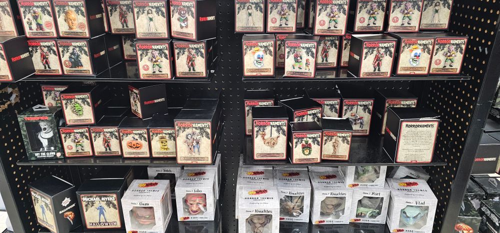 A shelf of Halloween Christmas tree ornaments