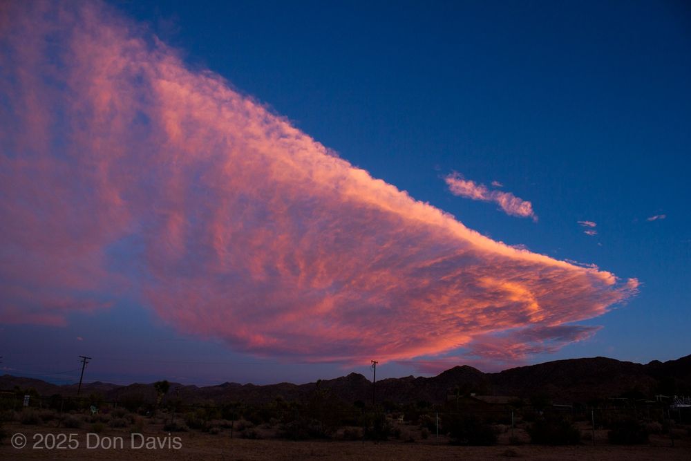 This photo of the sunset of July 26, 2025 shows the red lighting of the last rays of the Sun to make it through the atmosphere illuminating the bottom surface of the cloud mass.