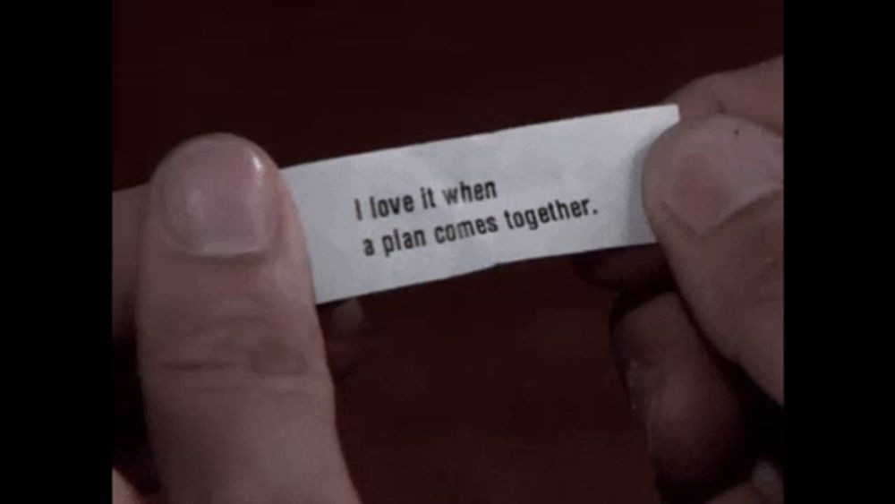 someone is holding a fortune cookie that says " i love it when a plan comes together "