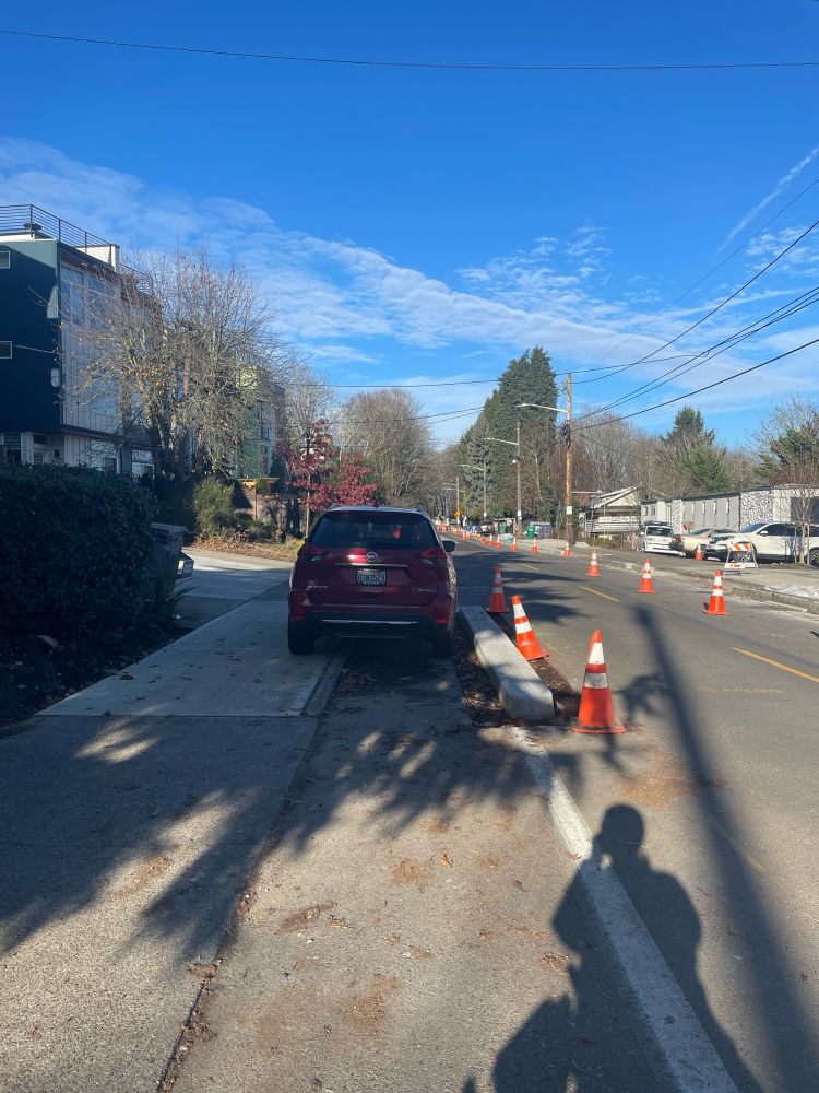 A car parked illegally on 15th Ave “protected” bike lane