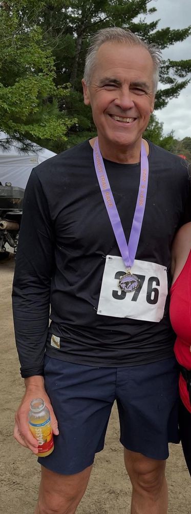 Prime Minister Mark Carney after running a 26K marathon greets and celebrates participants 