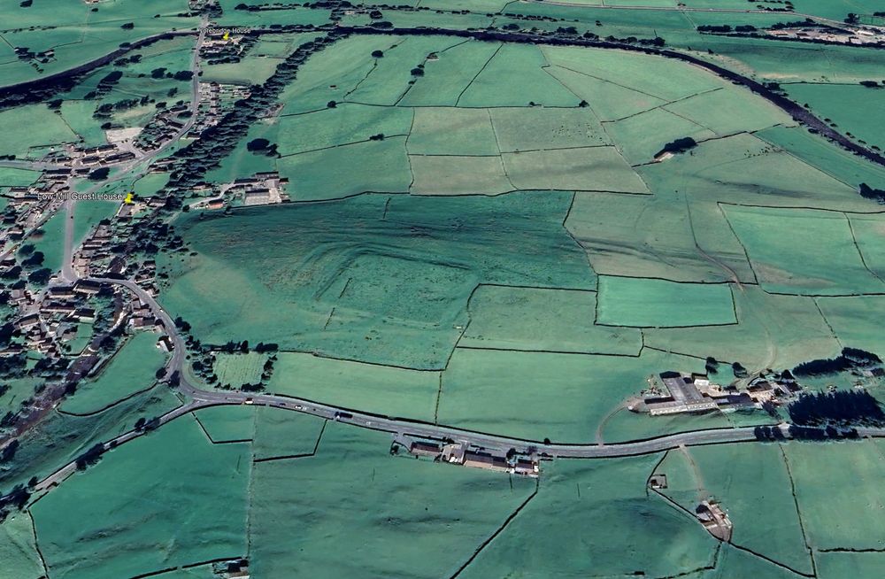 The earthwork remains of a Roman fort viewed from above and at an angle via Google Earth (13 Sept 2022). The village of Bainbridge is on the left.