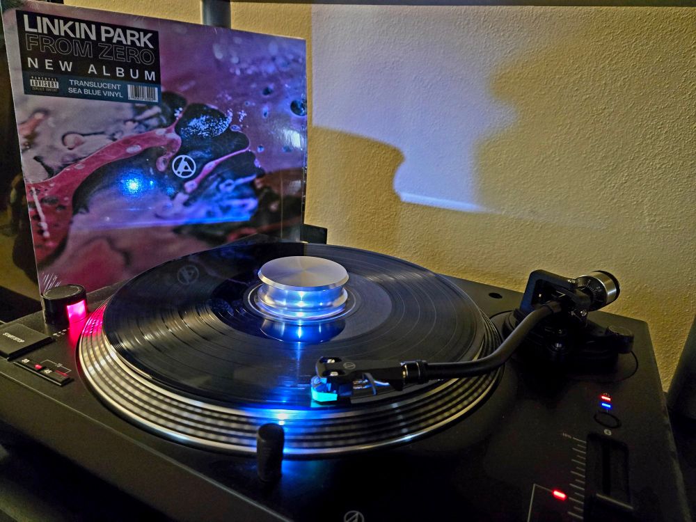 Turntable playing Linkin Park's new vinyl album with the album in background.