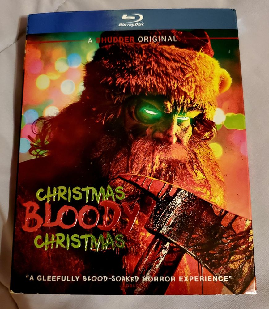 Cover of Christmas, bloody Christmas. A robot Santa holding a bloody axe
