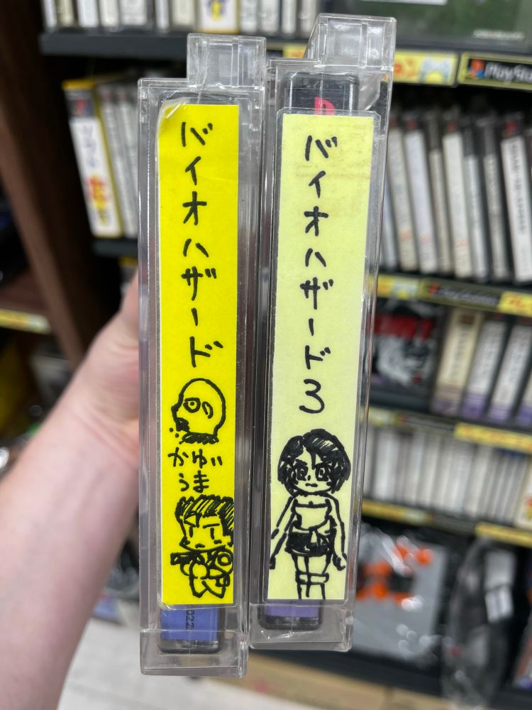 used copies of Resident Evil 1 & 3 with caricatures of Chris and Jill, respectively, drawn on the side. RE1 also has a decapitated head and “かゆいうま” (Japanese for “Itchy Tasty”)