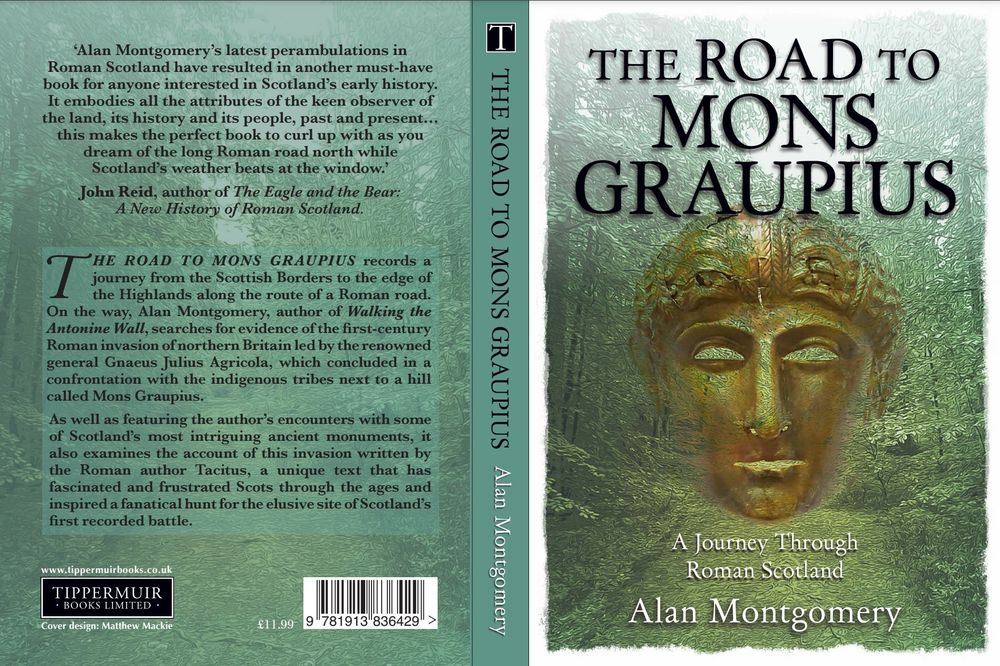 The cover of the book The Road to Mons Graupius by Alan Montgomery, which features a Roman bronze cavalry helmet floating about a tree lined Roman road.
