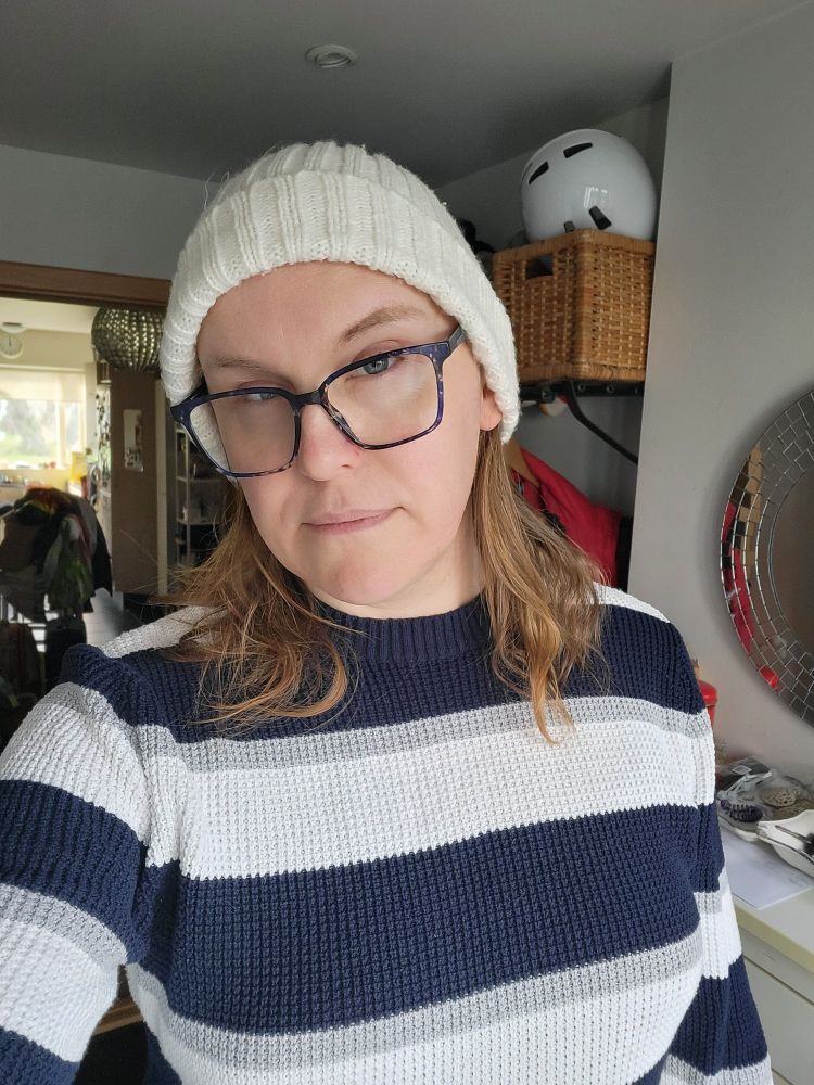 A selfie of me wearing a knitted jumper and a beanie