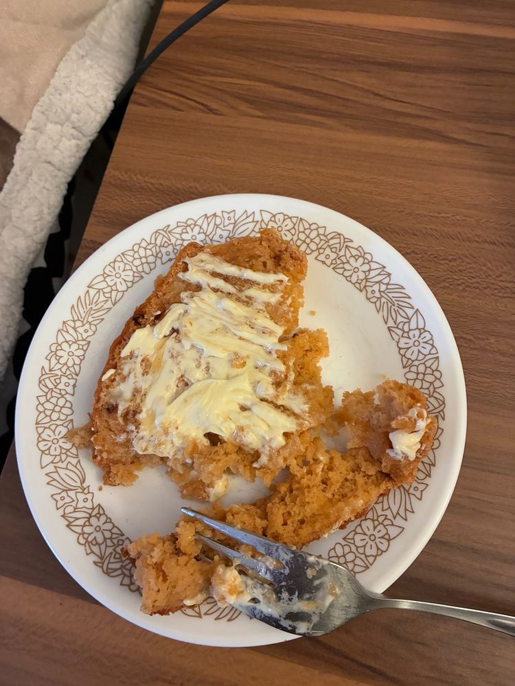 A photo of a slice of beer bread topped with honey and butter.