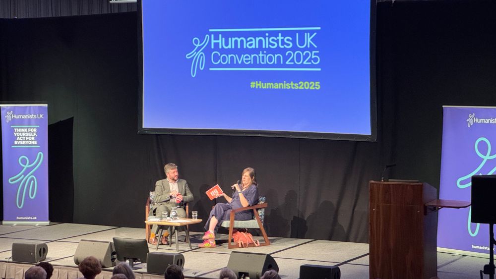 Riley on stage with Andrew Copson 