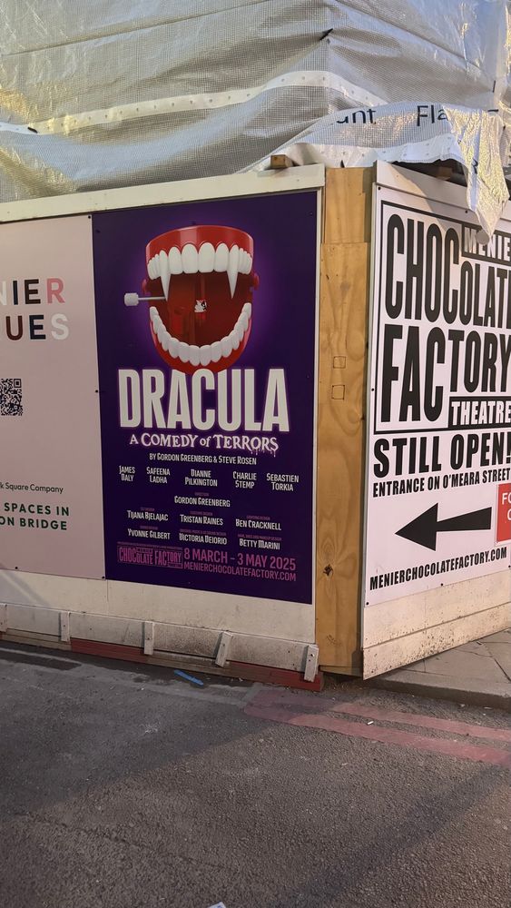 A poster of Dracula a comedy of terrors outside on the street. 