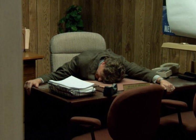 Meme picture of a guy face-planted on his desk with his arms outstreched