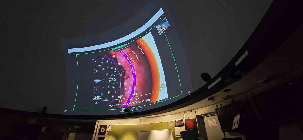 A diagram of the Hubble telescope's observational capacities, again projected onto a large domed screen.