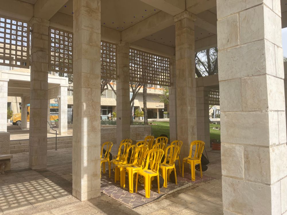 Yellow chairs at the university campus ber sheva in israel as symbol to the waiting for the hostages 