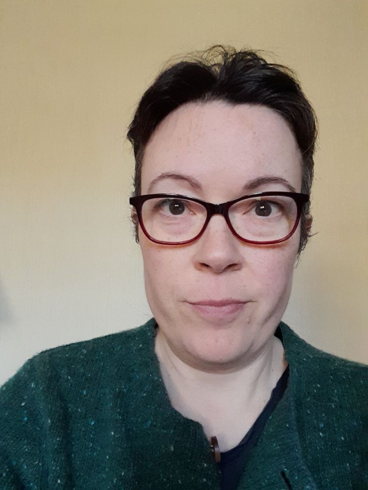 Me, looking at the camera, with very short hair