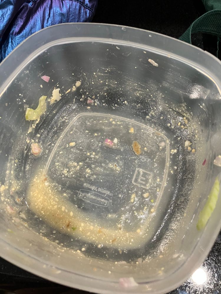 same container empty with just a little remnants of the aforementioned salad