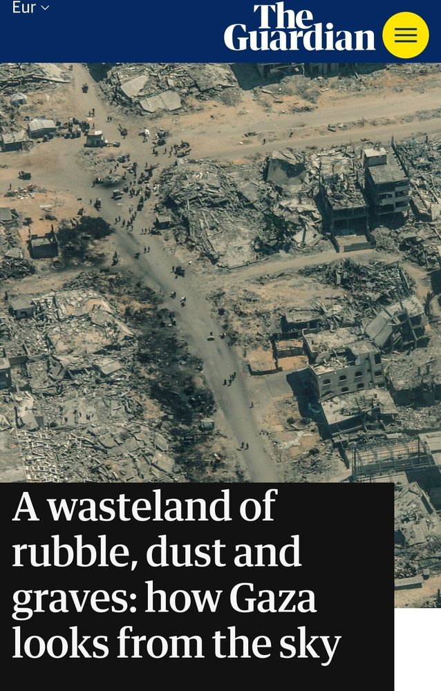 Aerial photo: Rubble on rubble in Gaza. People wander where once were streets. 