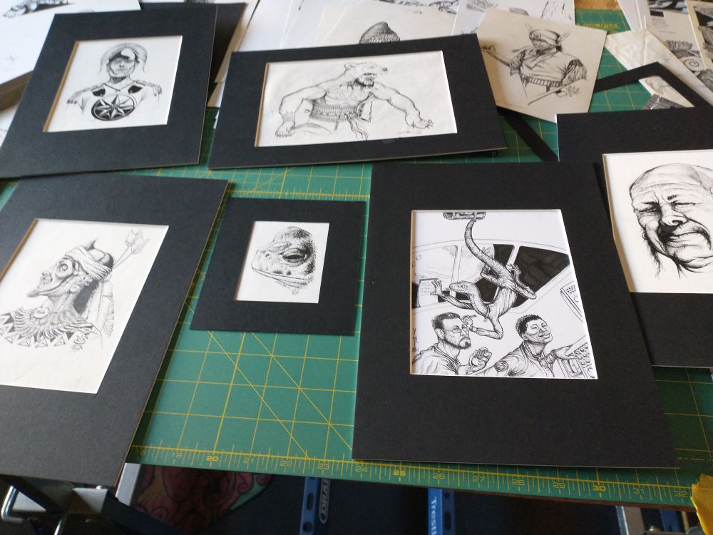 A bunch of black and white ink drawings mounted for sale 