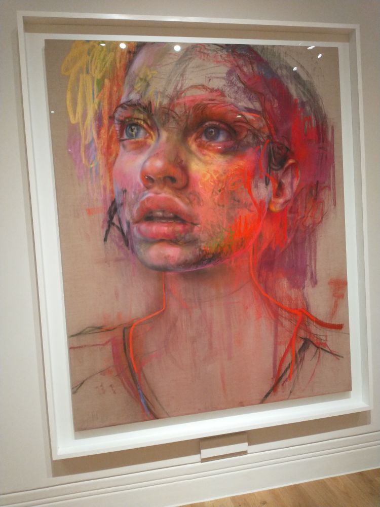 Another of Savilles portraits, of a young woman. Loose line work is covered by softer pastels then almost fluorescent pastels are deposited on top. But the eyes are like pools. It is hard to tell where sclera gives way to iris, and then to pupil. 