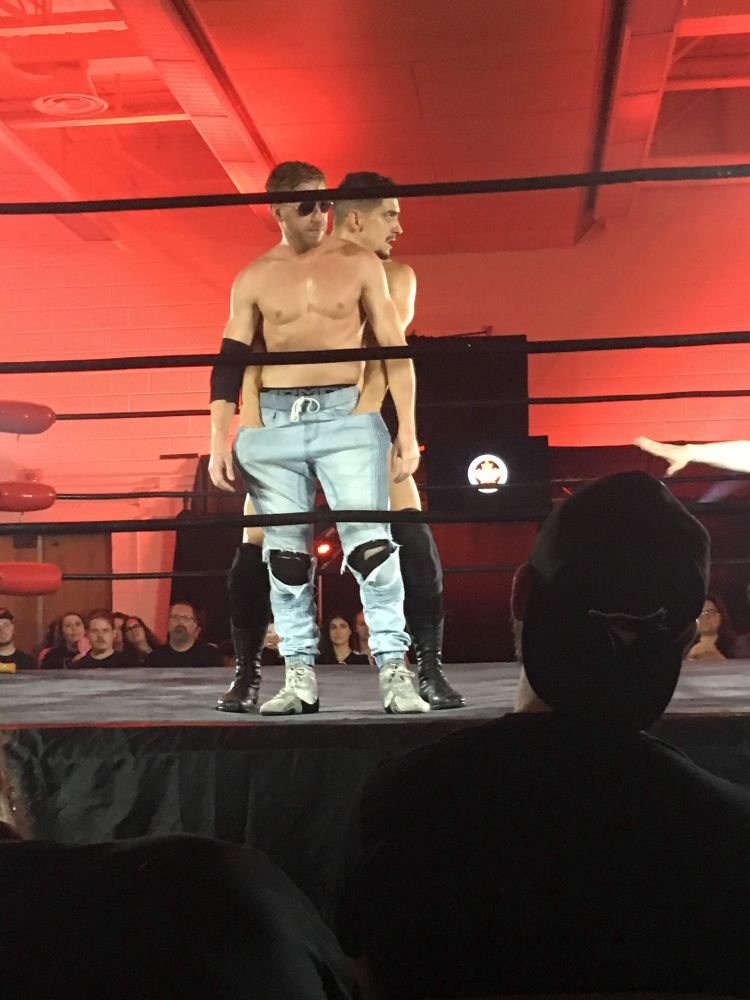 Psycho Mike has his hands stuck in the pockets of Orange Cassidy’s jeans