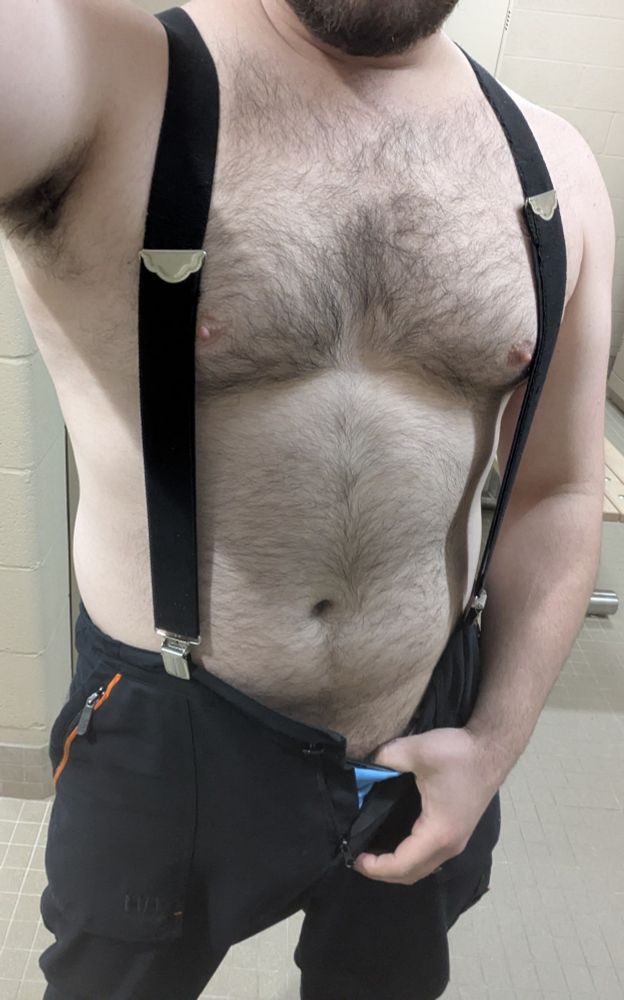 Me at work only wearing pants and suspenders leaving my burly torso exposed.
