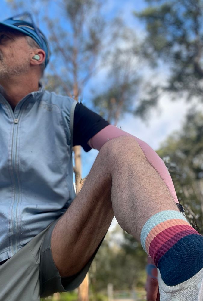 Middle aged jogger stretches on a picnic table while rest of neighbourhood sleeps.