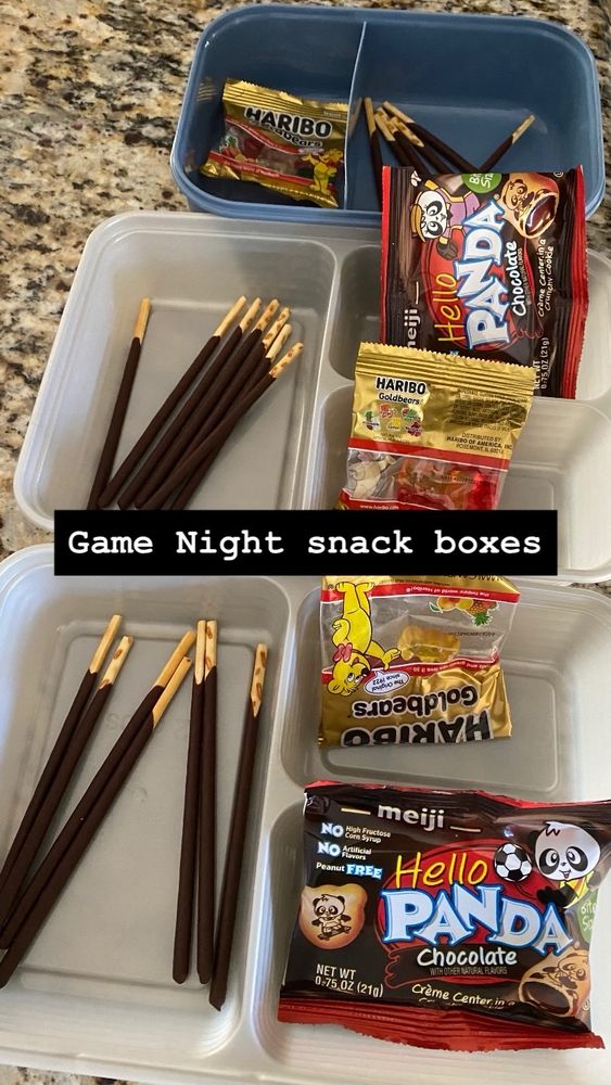 Plastic Tupperware with pocky sticks, Hello Panda chocolate pandas, and Haribo gummy snacks.