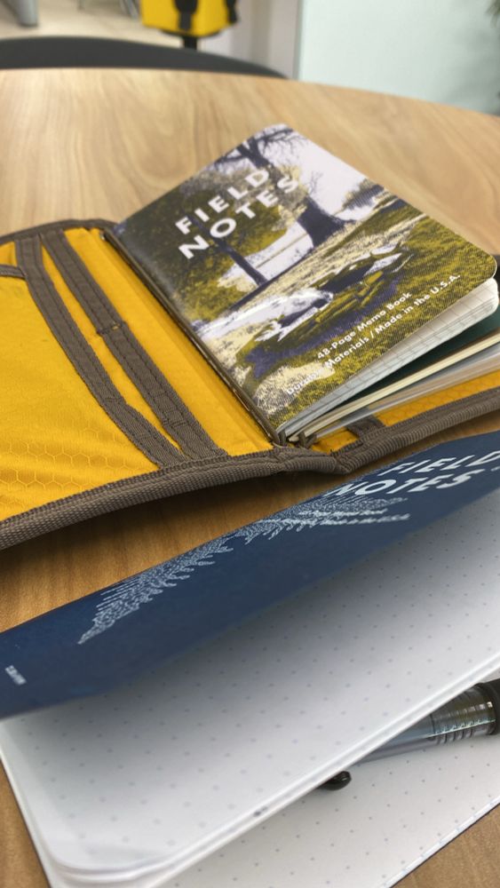 Some notebooks a tired dad is using while in a waiting room