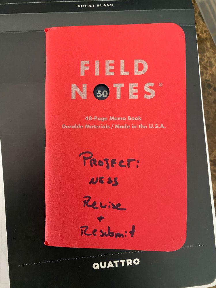 A Field Notes Fifty Edition cover, with “Project: NESS Revise & Resubmit” written on the cover.
