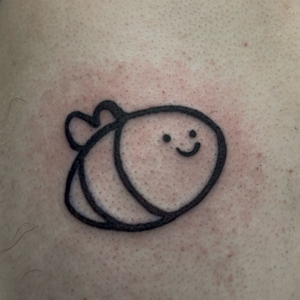 A tattoo of the Let’s Learn Everything logo, a lineart sketch of a bumblebee!