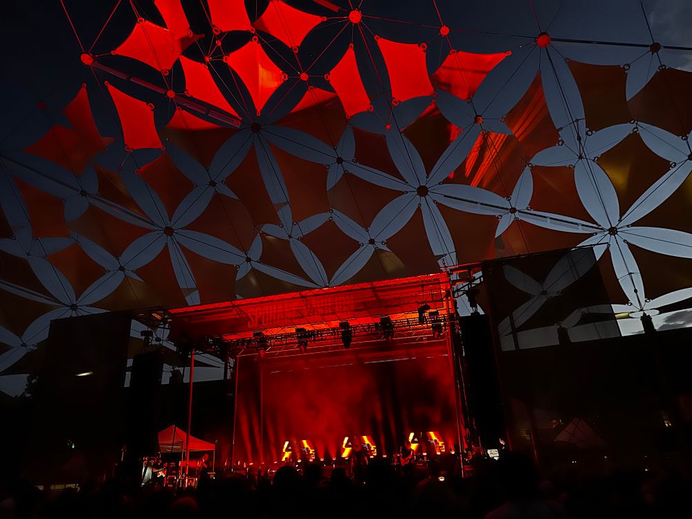 Death cab for cutie on stage with red lights. 