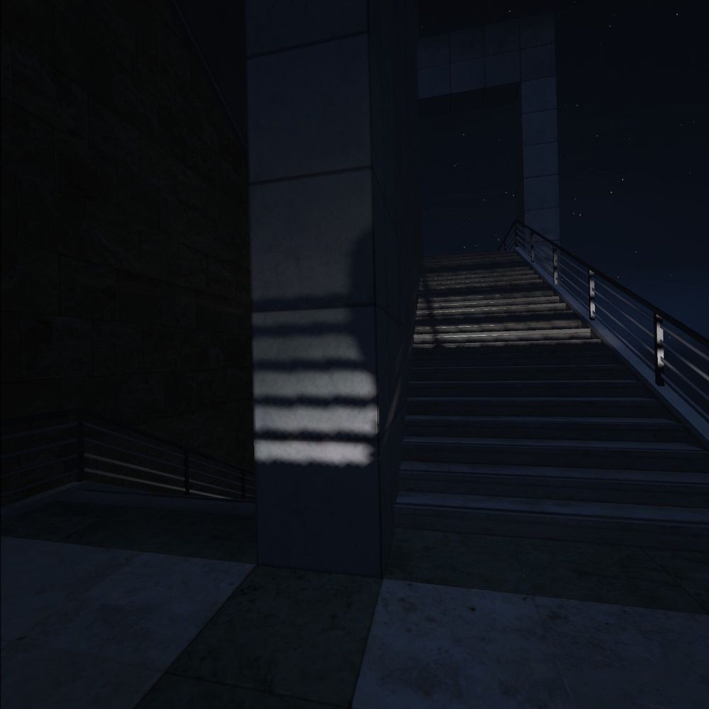 A familiar sight of that platue between a stairwell where the stairs change direction 90 degrees at a time. Stairs are stone/concrete and shadows illuminate the dividing wall creating window blind like shadows from the wire railing onto wall and upstairs. A lone arch awaits.