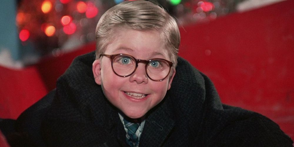 Ralphie from 'A Christmas Story' clinging to a red slide in a department store, wearimg thick-rimmed glasses