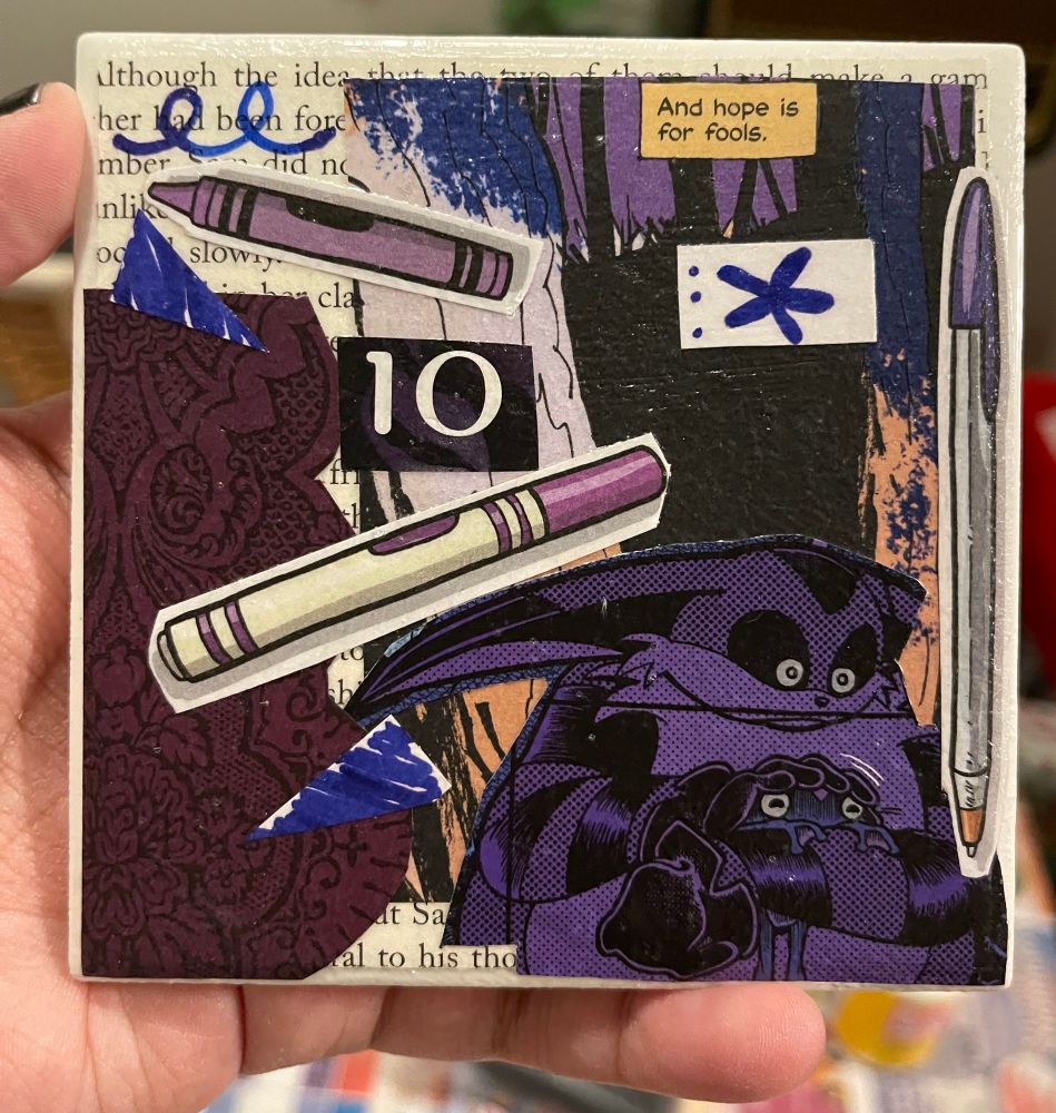 Night is holding up a white tile that has many comic book and graphic novel clippings made into a collage. The clippings are all purple!