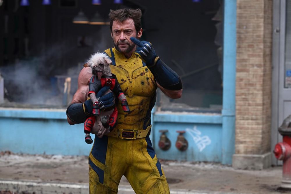Wolverine carrying Dogpool and flipping you the bird