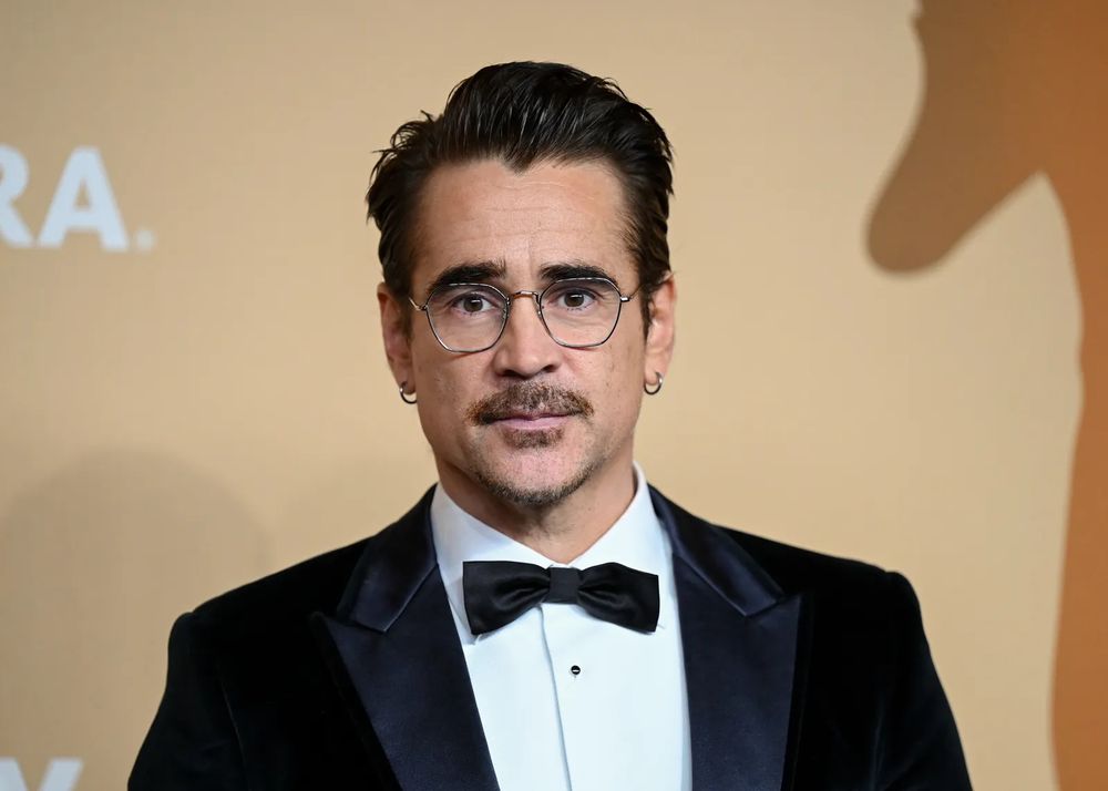Irish actor Colin Farrell wearing glasses and a moustache