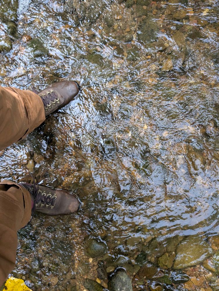 Water flowing over a pair of boots 