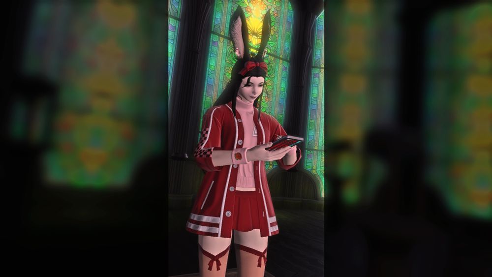 Gridania windows as background.
Lucy is standing and browsing on her phone. She's wearing red clothes inspired by a friend.