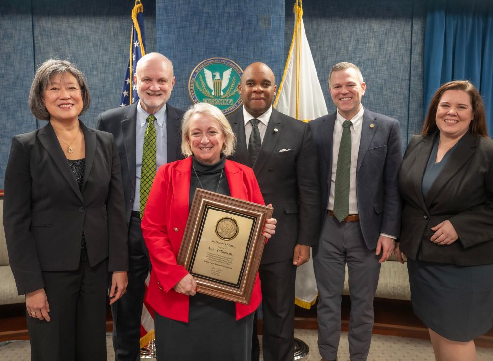 Mary O'Driscoll, center, holding the Chairman's Medal award, with members of the Federal Energy Regulatory Commission.