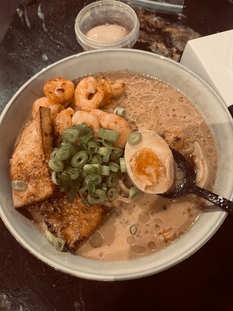 Bowl of ramen with tofu, egg, prawns and spring onion 