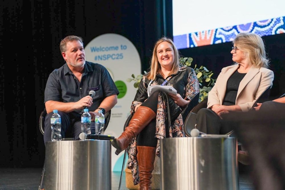 Tama Leaver, Carla Sargeant & (Headspace), and Jacqueline McGowan-Jones (the Western Australian Commissioner for Children and Young People), on stage with microphones.