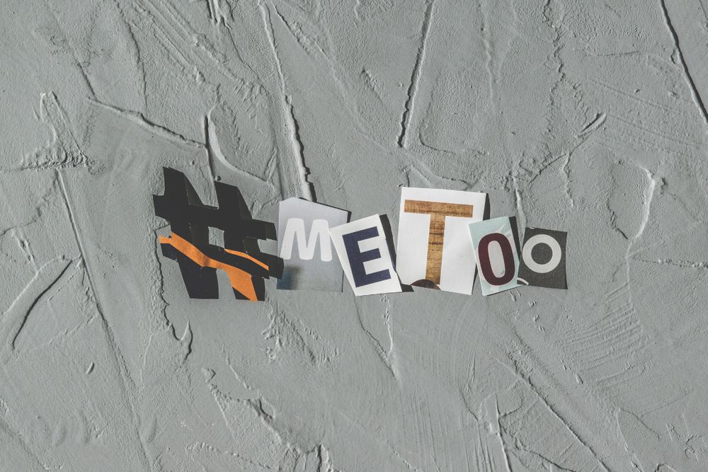 A collage-style cutout of the hashtag ‘#MeToo’ on a textured gray background, symbolizing the movement against sexual harassment and assault.