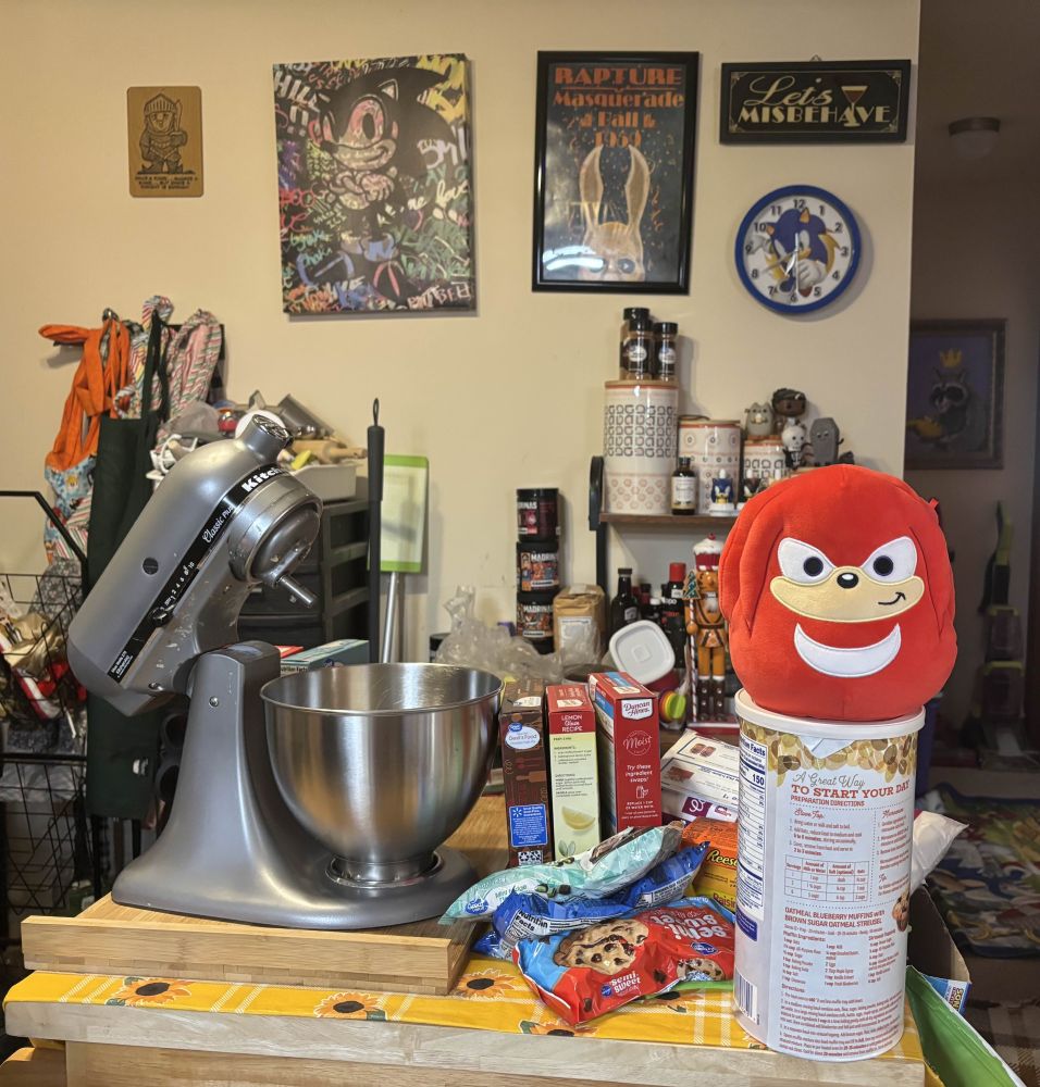 Knuckles is sitting on a container of oatmeal next to baking equipment. He's here to help?