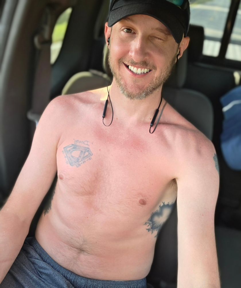 Smiling hard driving shirtless back from the beach