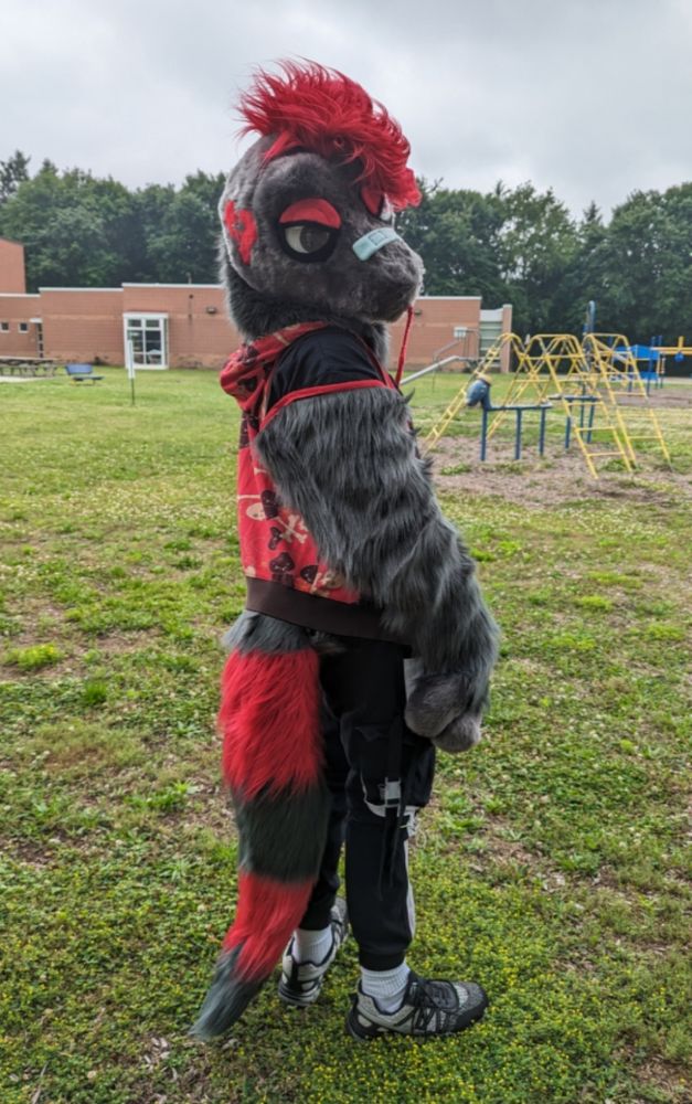 A grey and red "Emo" themed worm-on-a-string fursuit, made my Saros Suitworks.