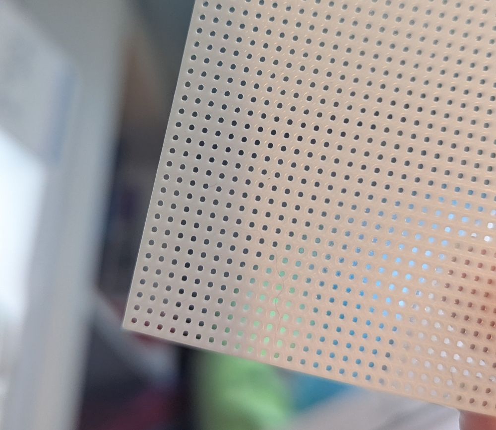A closer image of the mesh. It's white plastic with tiny circular holes.