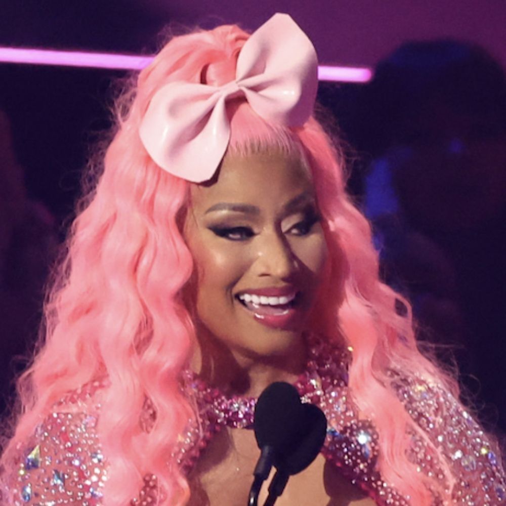 Pop/rapper nicki minaj with long pink hair a pink bow and glitter outfit
