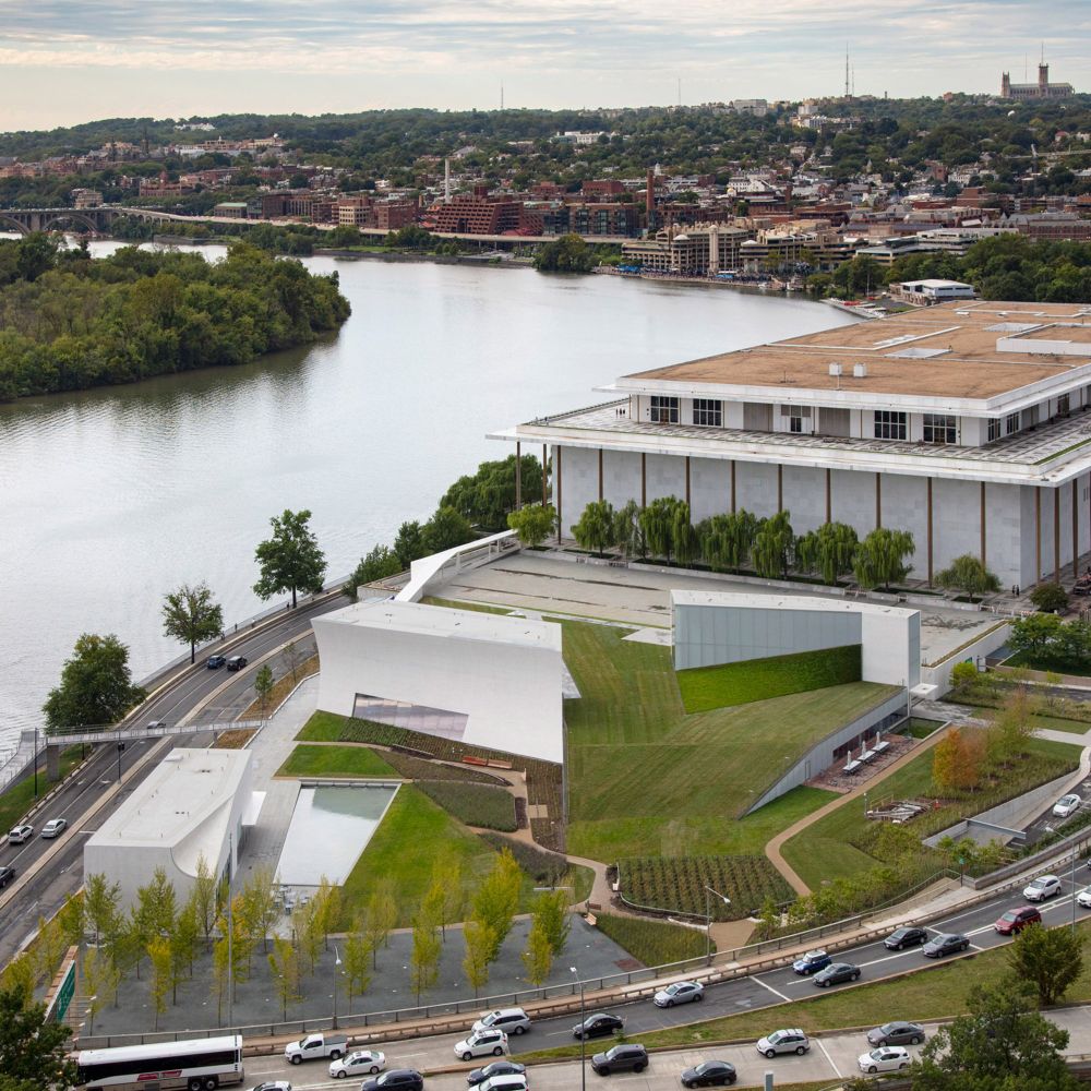 Steven Holl Architects has nestled "much-needed" performance spaces for the Kennedy Center in Washington DC under a grassy slope topped by three white-concrete pavilions.