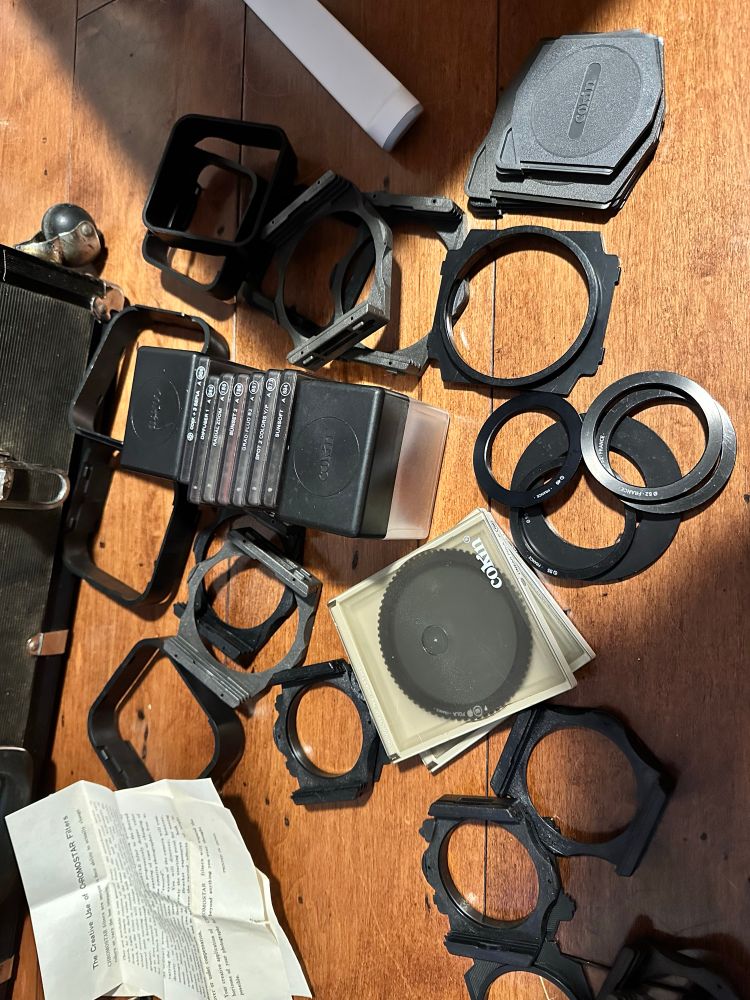 A bunch of Cokin filters, holders, and accessories for film cameras. 